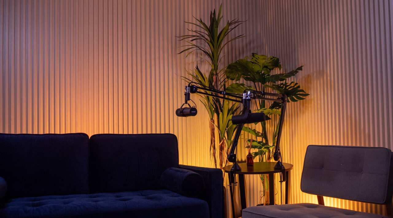 The studio at rest, lit set with sofa and microphones, no crew.