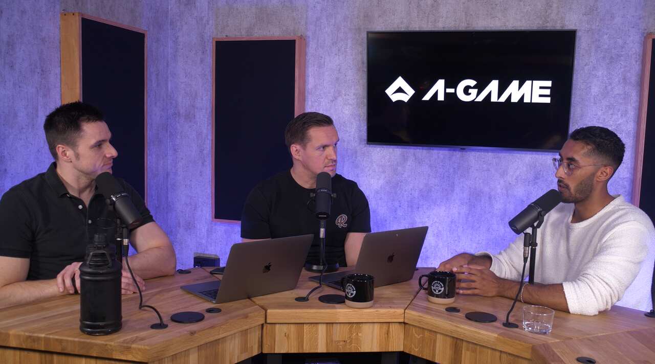 Three executives in conversation on camera in the studio.
